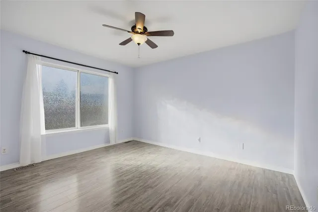 wooden floor in an empty room with a window