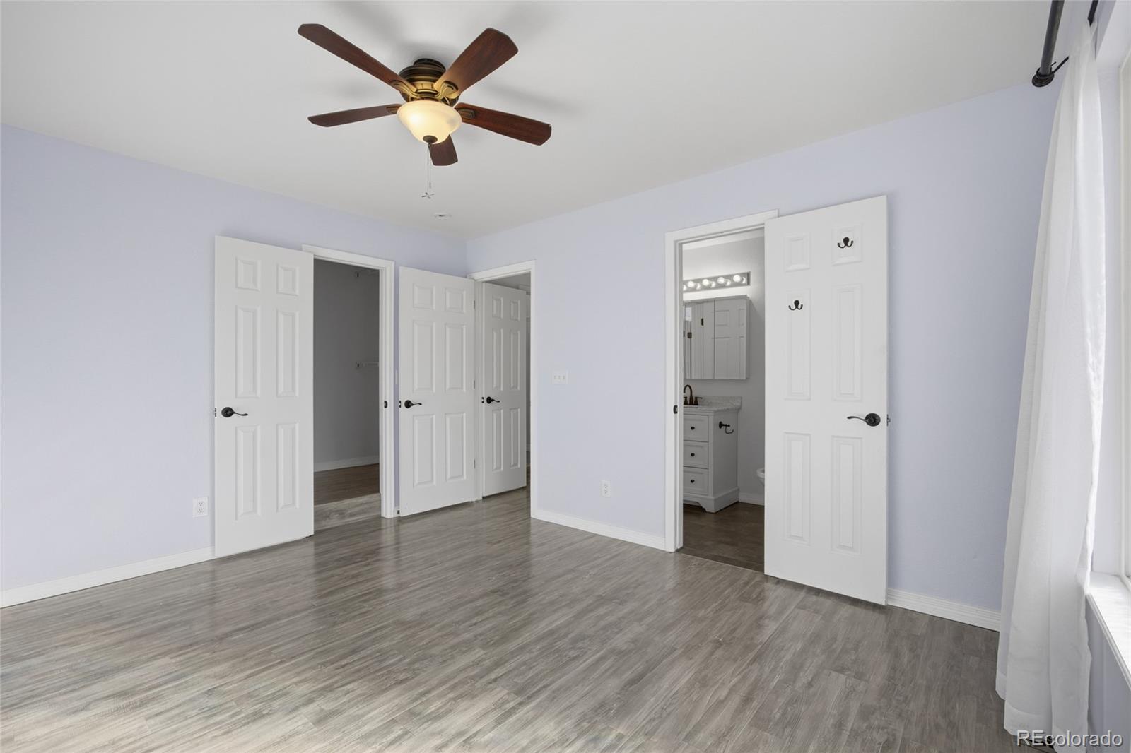 4531 Gibraltar Street Denver, CO 80249 - Photo 12 of 24 a view of an empty room with wooden floor