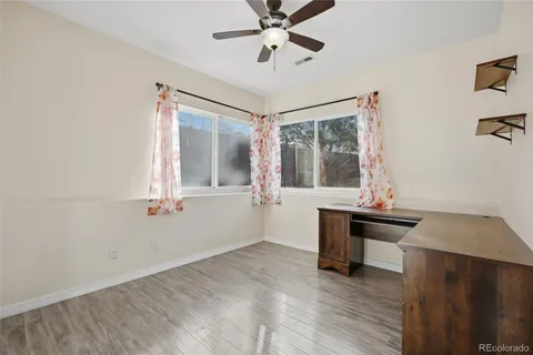 a view of a workspace with furniture and a window