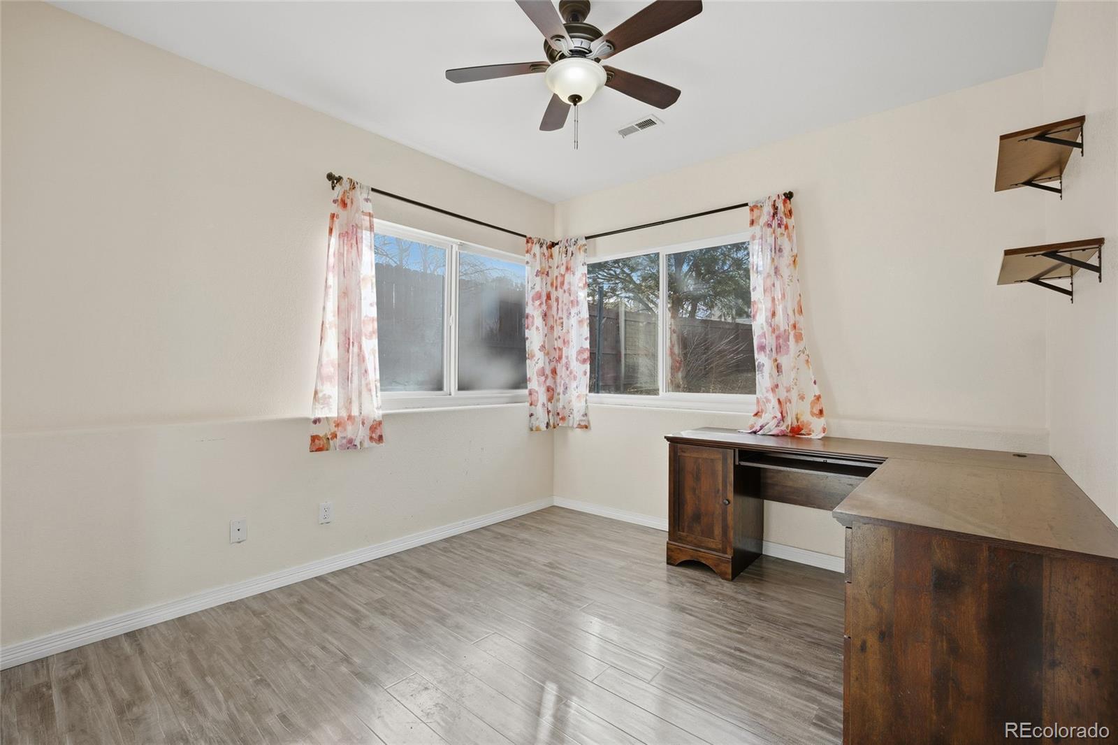4531 Gibraltar Street Denver, CO 80249 - Photo 15 of 24 a view of a workspace with furniture and a window