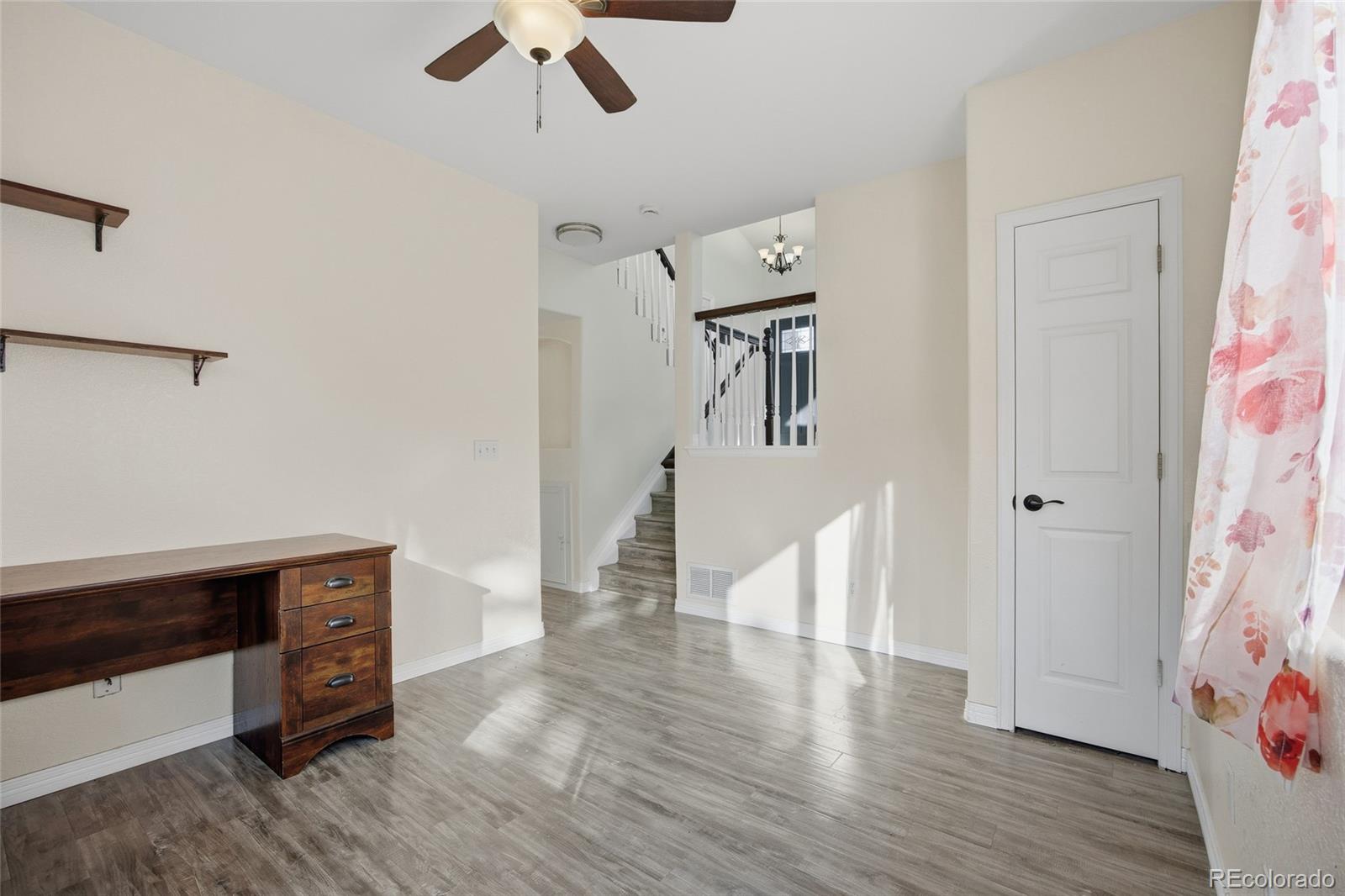 4531 Gibraltar Street Denver, CO 80249 - Photo 16 of 24 a view of entryway with furniture and wooden floor