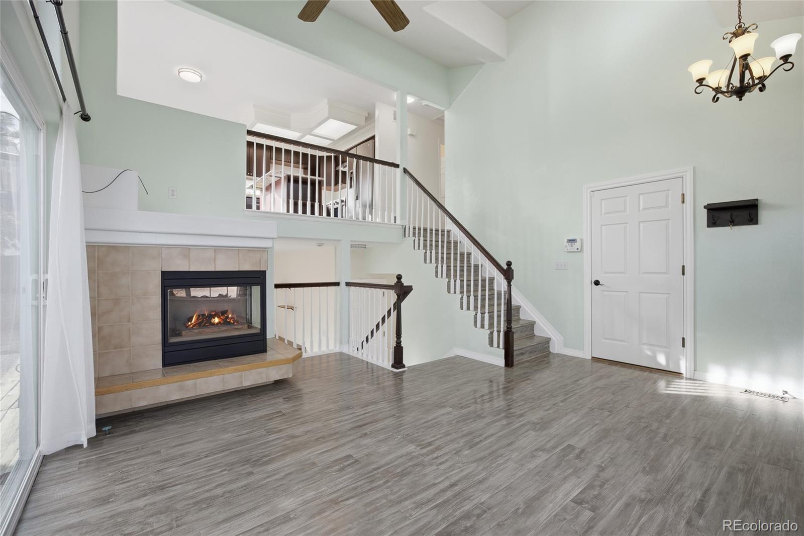 4531 Gibraltar Street Denver, CO 80249 - Photo 5 of 24 a view of an entryway with wooden floor fireplace and a window