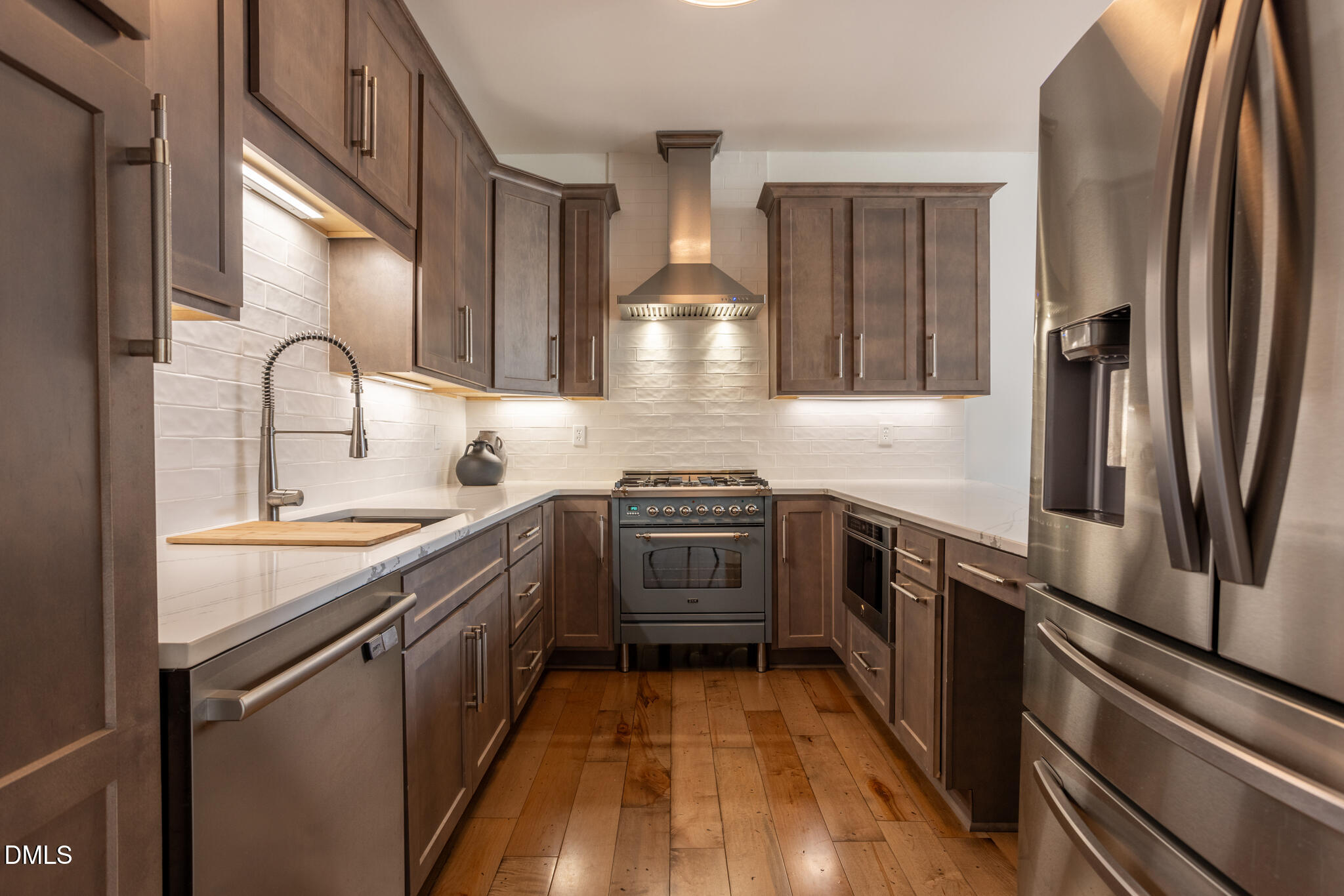 708 Constitution Drive, Unit F Durham, NC 27705 - Photo 12 of 53 a kitchen with stainless steel appliances granite countertop a stove and a sink