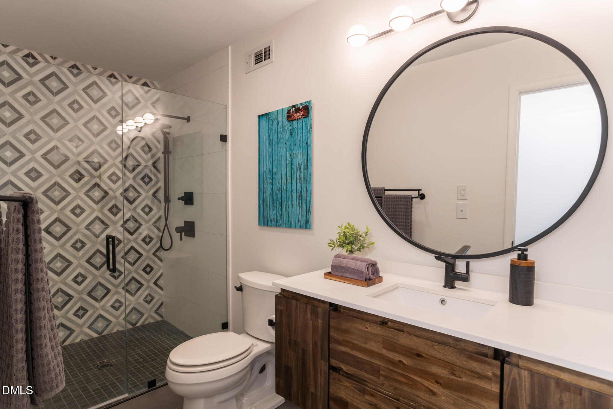 708 Constitution Drive, Unit F Durham, NC 27705 - Photo 34 of 48 a bathroom with a sink mirror vanity and toilet