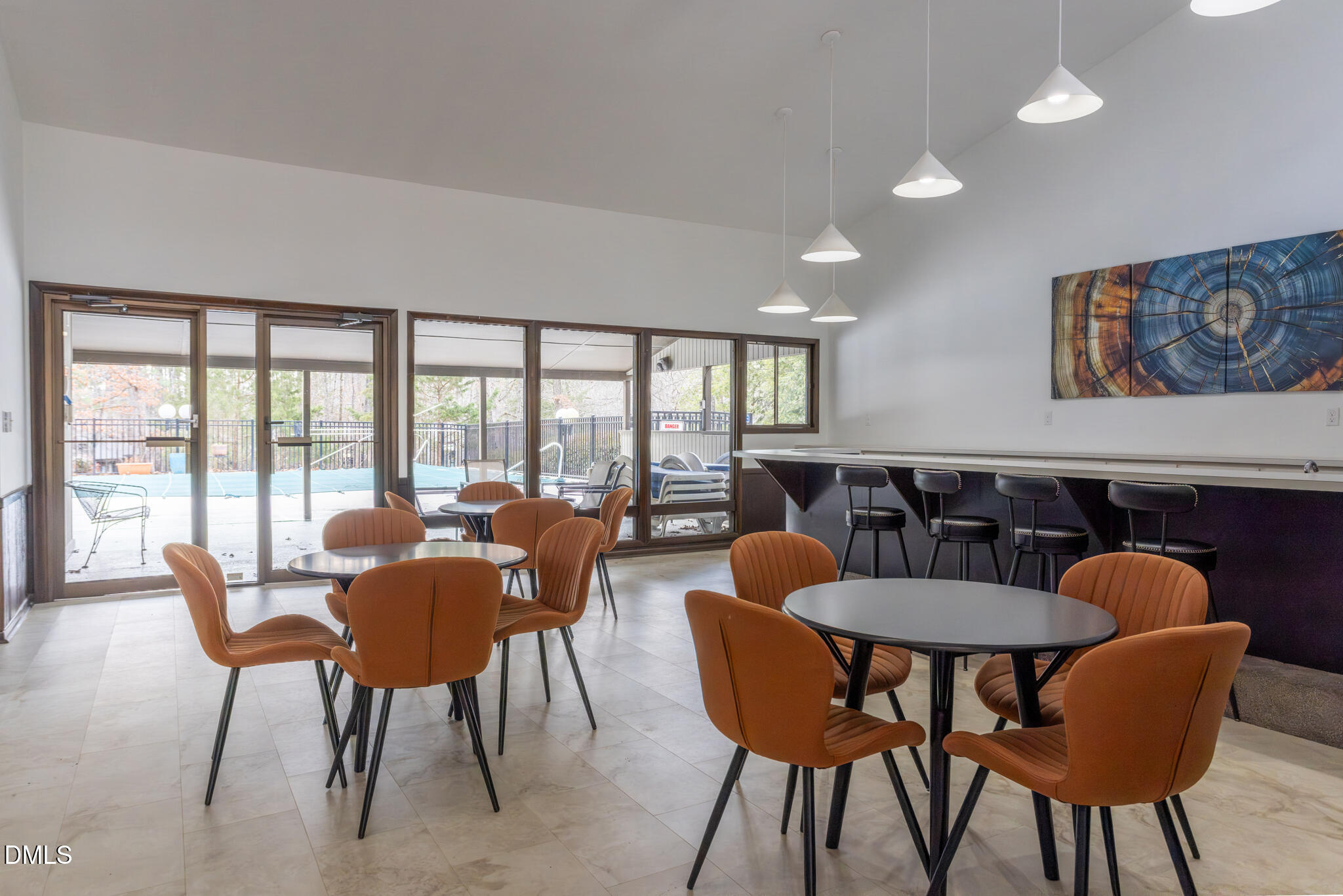 708 Constitution Drive, Unit F Durham, NC 27705 - Photo 50 of 53 a view of a dining room with furniture large windows and wooden floor