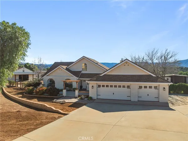 a view of a large house with wooden fence