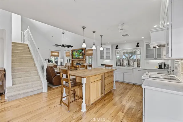 a kitchen with stainless steel appliances kitchen island hardwood floor sink and stove