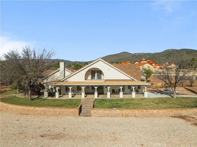 a view of swimming pool with outdoor seating and a patio