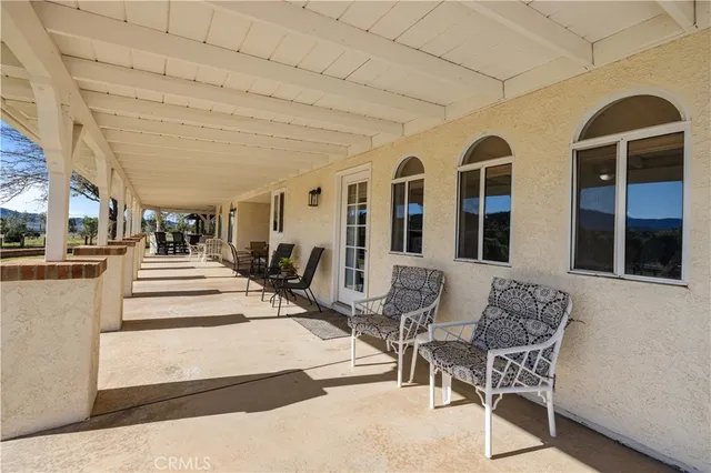 a living room with furniture a flat screen tv and a window