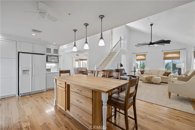 a dining area with stainless steel appliances kitchen island granite countertop a table and chairs in it