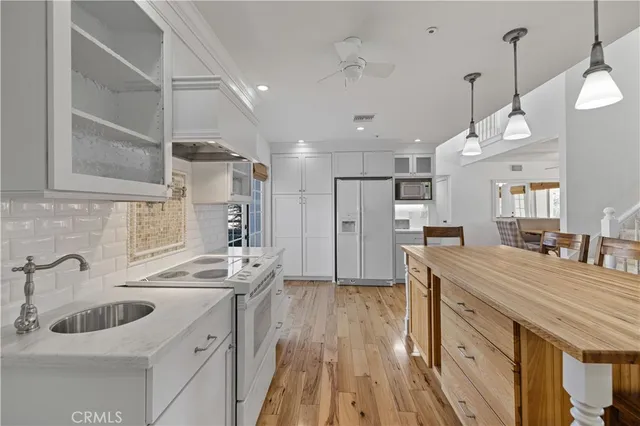 a living room with furniture a fireplace and a large window