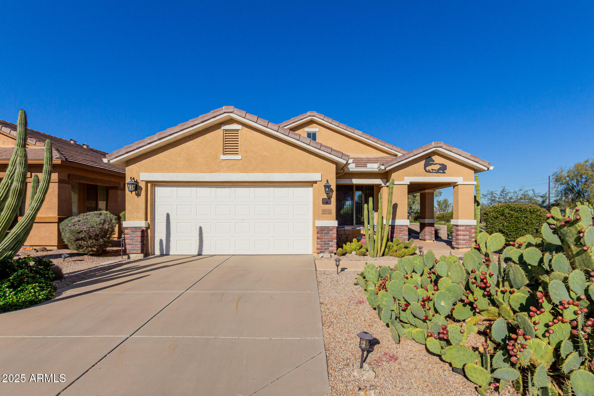 a front view of a house with a yard and outdoor seating