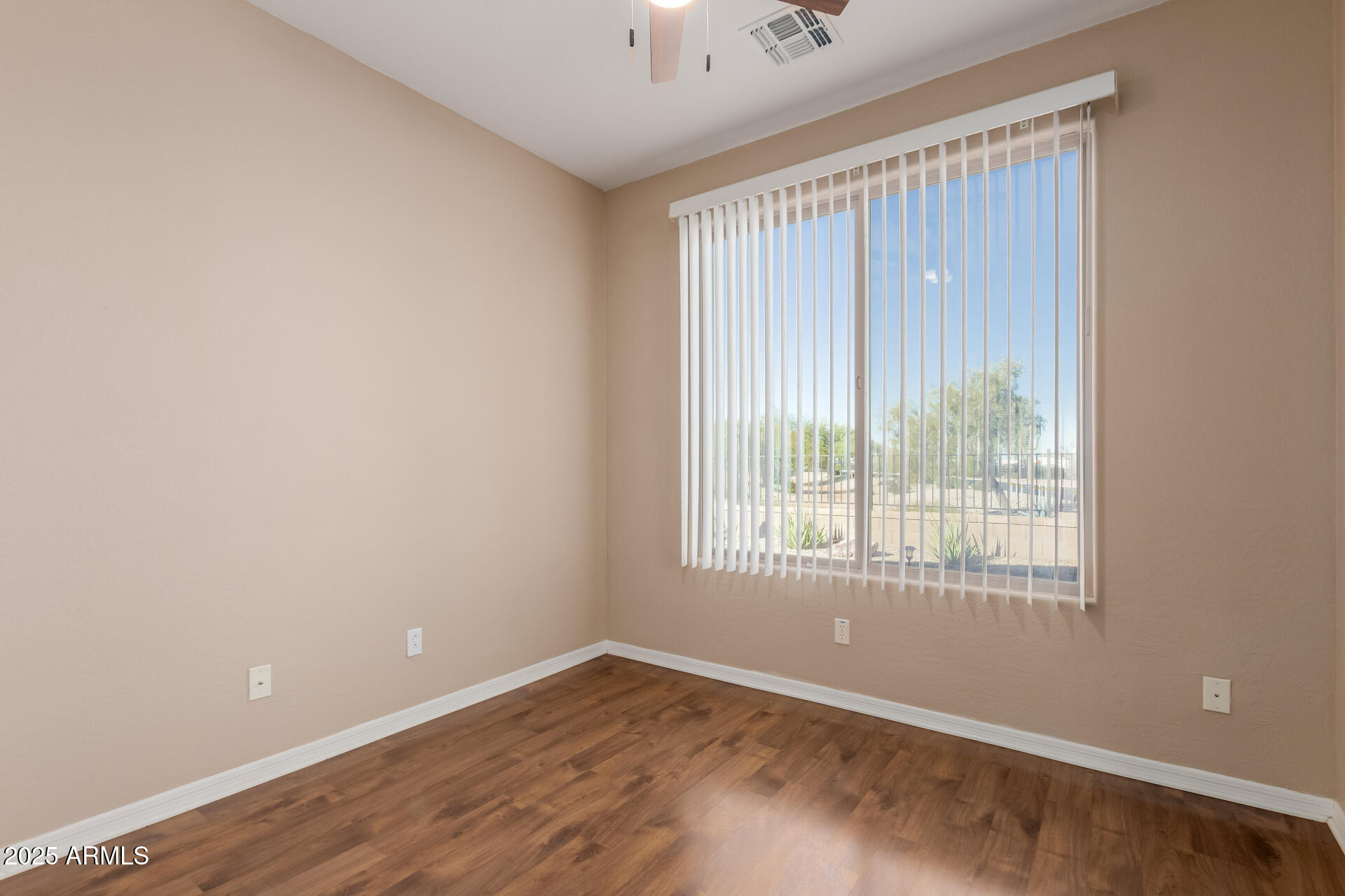 32270 Echo Canyon Road San Tan Valley, AZ 85143 - Photo 12 of 28 a view of an empty room with wooden floor and a window