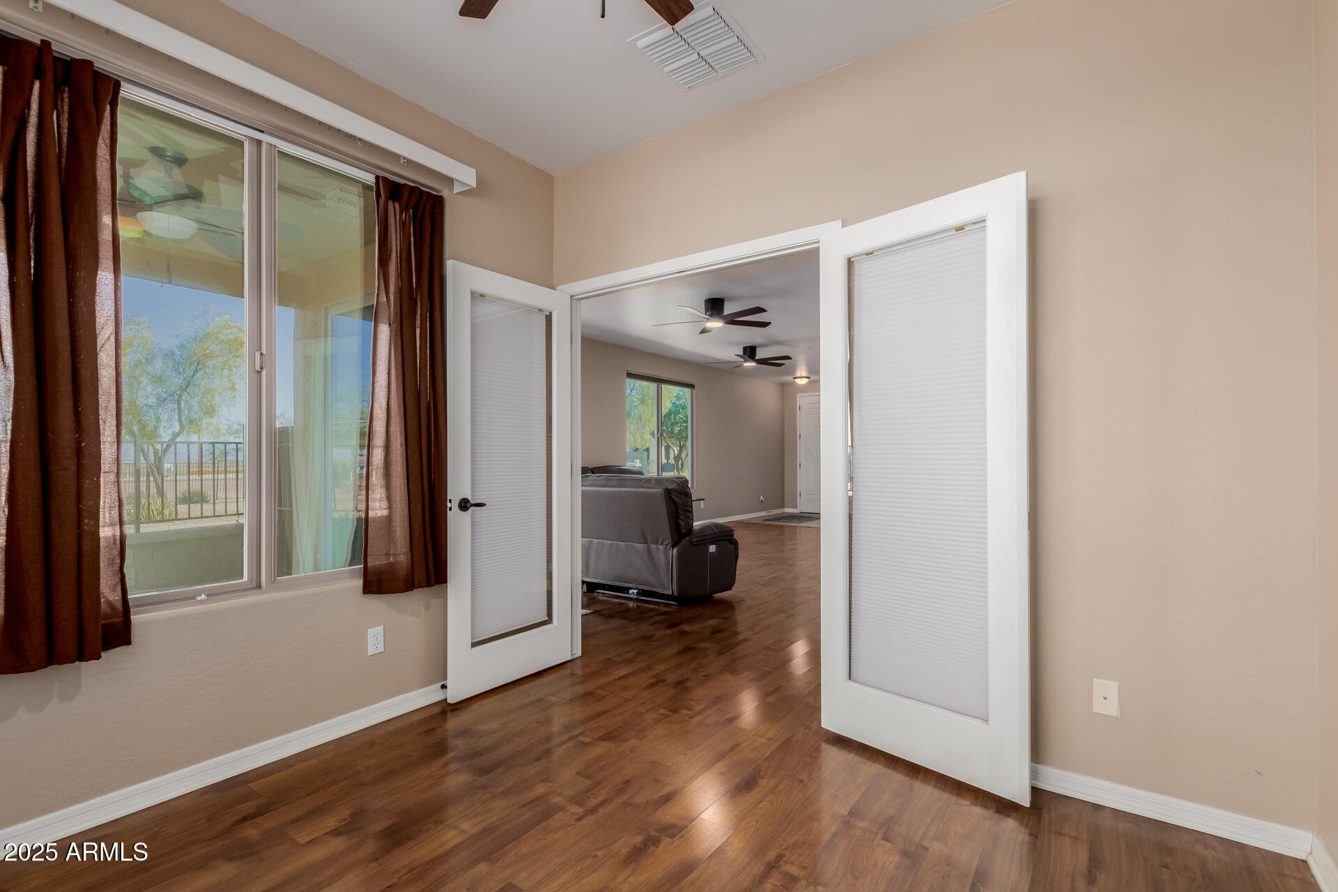 32270 Echo Canyon Road San Tan Valley, AZ 85143 - Photo 13 of 28 a view of a livingroom with wooden floor and a bedroom