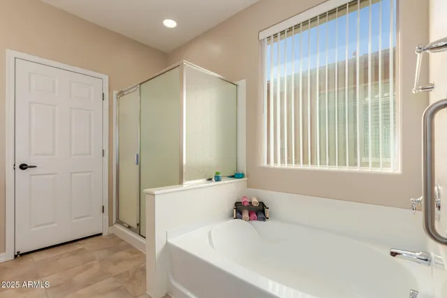 a bathroom with a bathtub and a shower