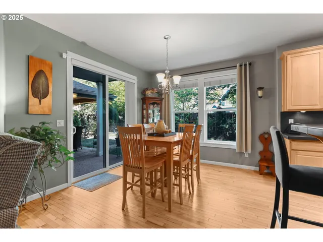 a dining room with furniture a chandelier and wooden floor