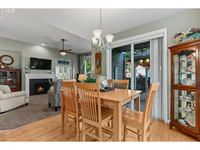 a view of a dining room with furniture a chandelier and wooden floor