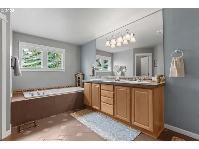 a bathroom with a tub sink and a mirror