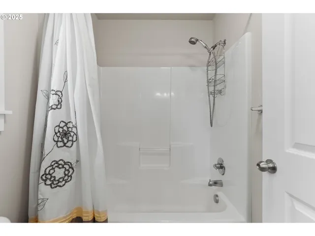 a bathroom with a shower and a sink