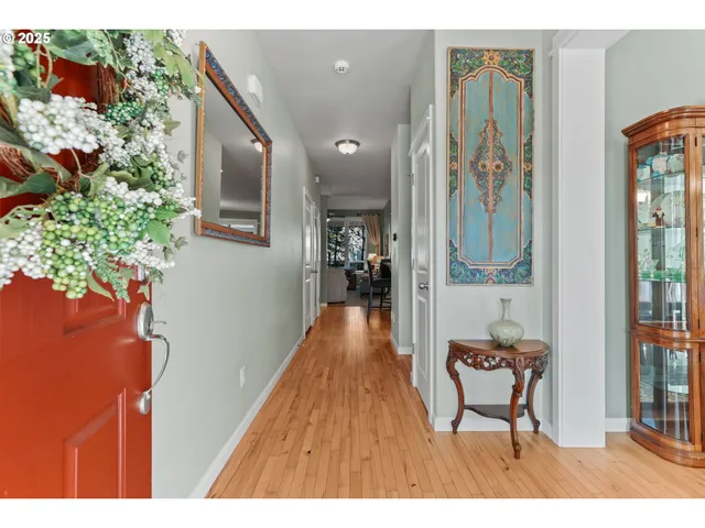a hallway with a dining table and a chandelier