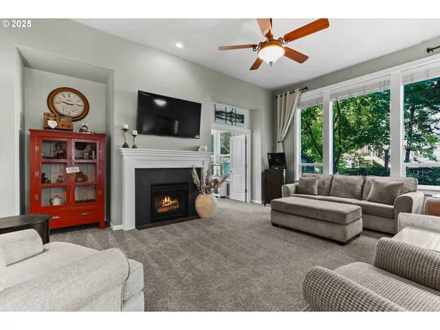 a living room with furniture a flat screen tv and a fireplace