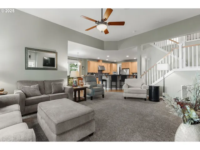 a living room with furniture and a chandelier