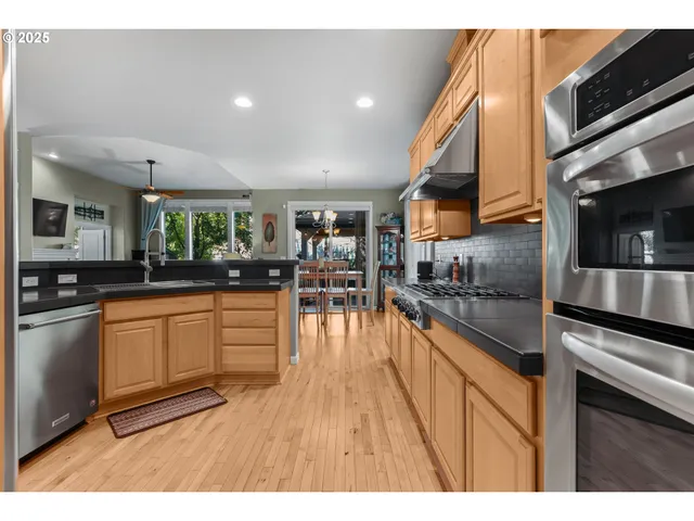 a kitchen with stainless steel appliances granite countertop a sink and cabinets