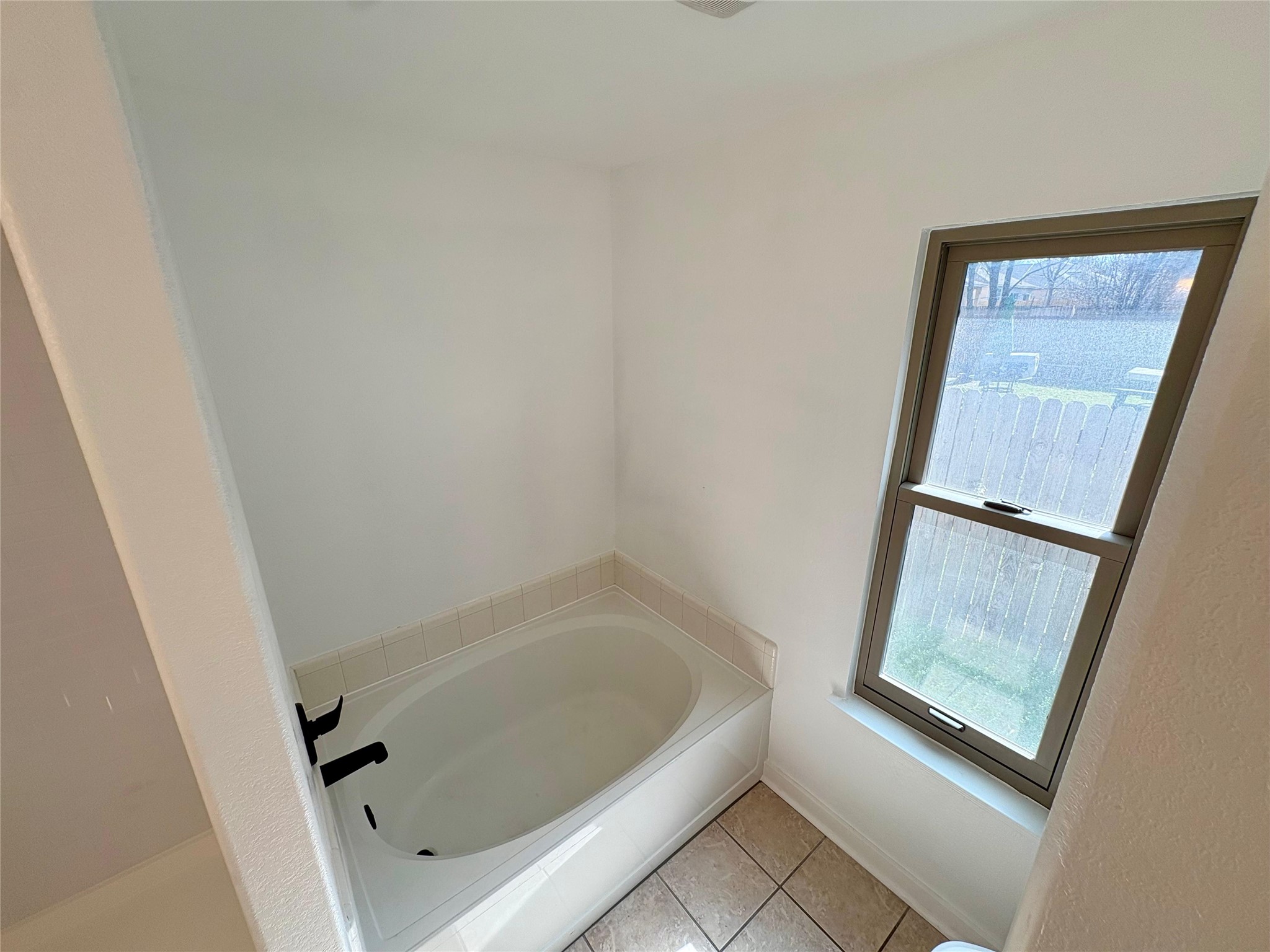 8003 Bannock Lane Austin, TX 78747 - Photo 23 of 40 Master bath with a bath and light tile patterned floors