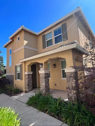 a front view of a house with a garden