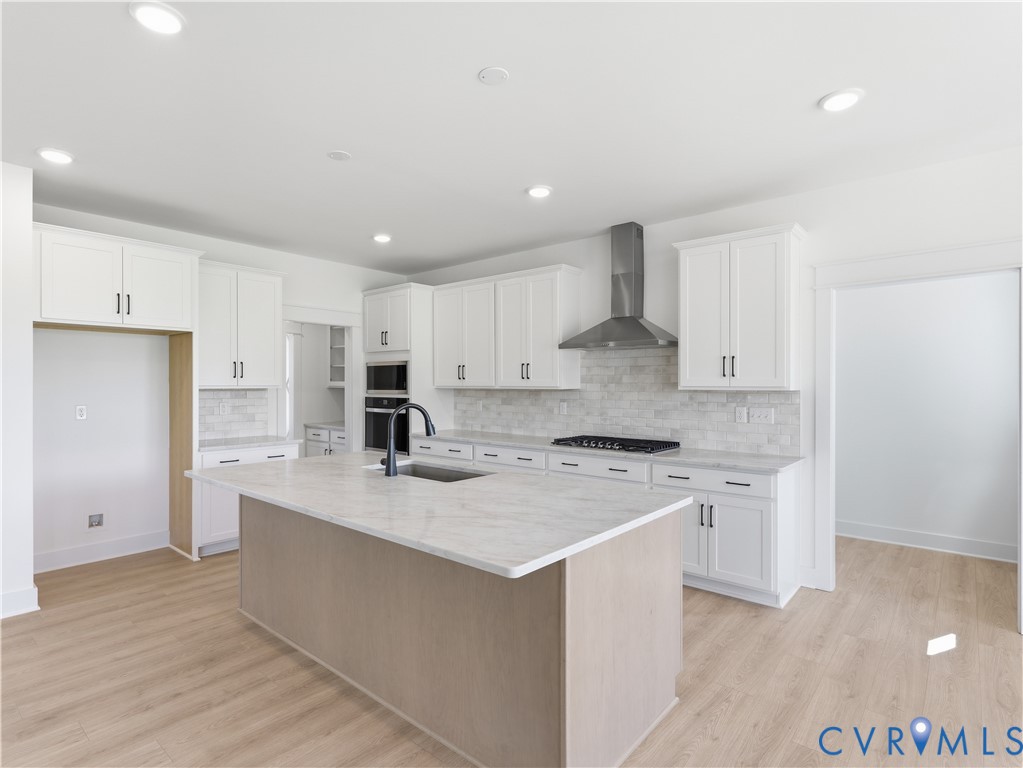18112 Copper Fox Loop Moseley, VA 23120 - Photo 8 of 29 a kitchen with a stove a sink a refrigerator and cabinets