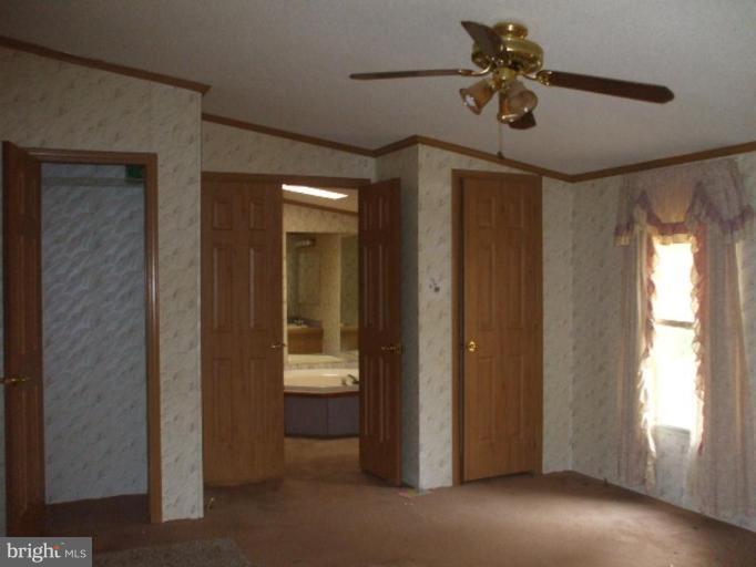 295 Buckler Road Huntingtown, MD 20639 - Photo 8 of 9 a view of room with a ceiling fan and window