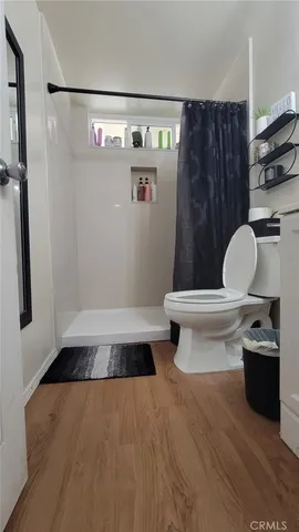 a bathroom with a toilet and a shower
