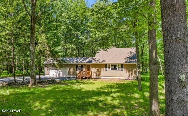 143 Ridge Road Pocono Lake, PA 18347 - Photo 2 of 3 a view of a patio with table and chairs and a large tree