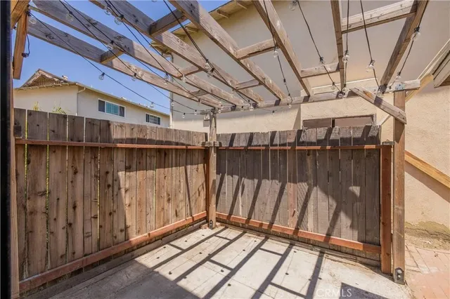a view of a house with a yard and potted plants