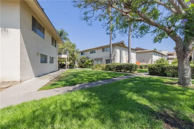 a view of a garden with a building in the background
