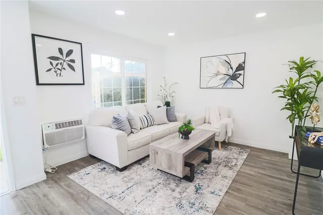 a living room with furniture and a potted plant