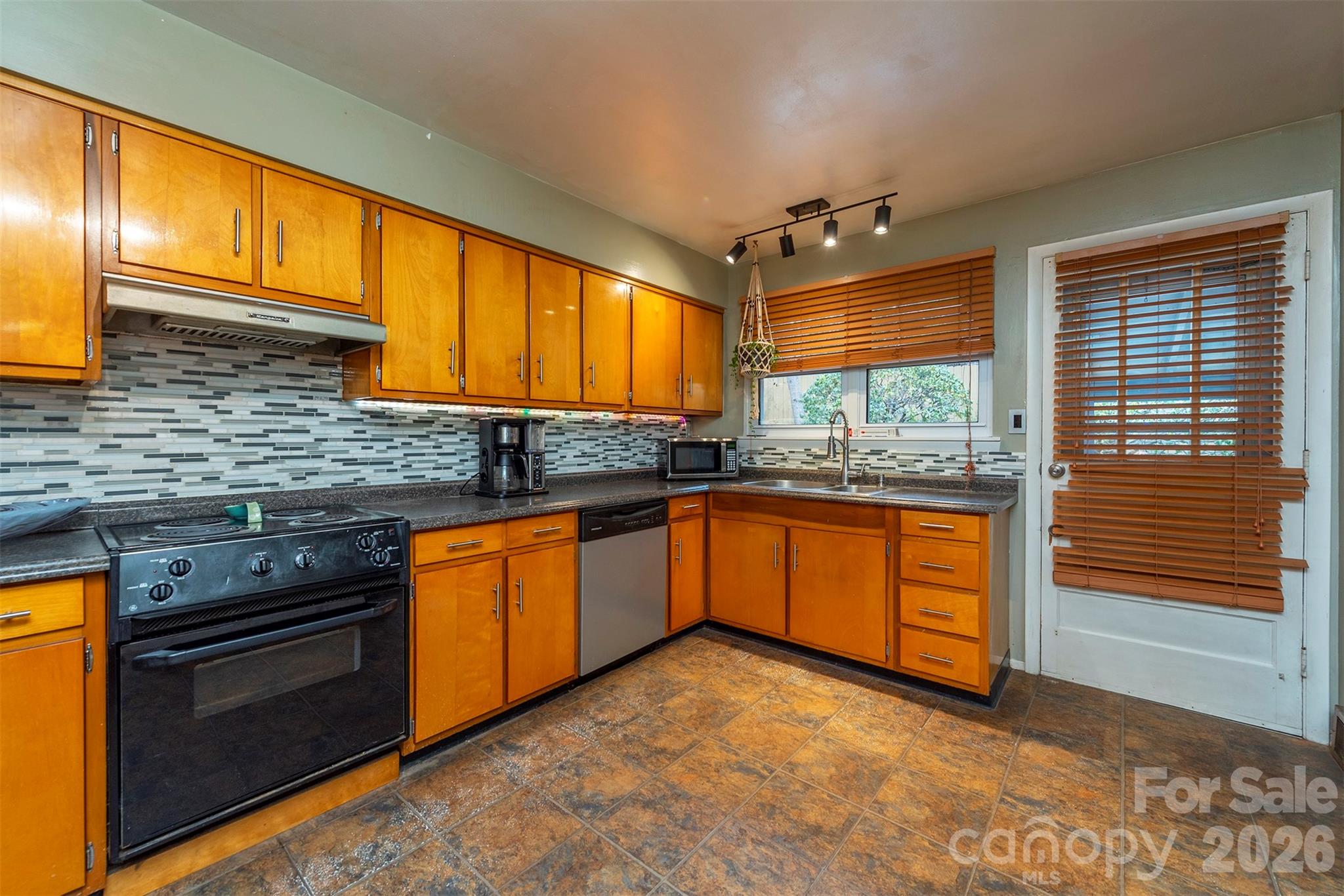4 Stockwood Road Asheville, NC 28803 - Photo 13 of 41 a kitchen with granite countertop stainless steel appliances a stove sink and cabinets