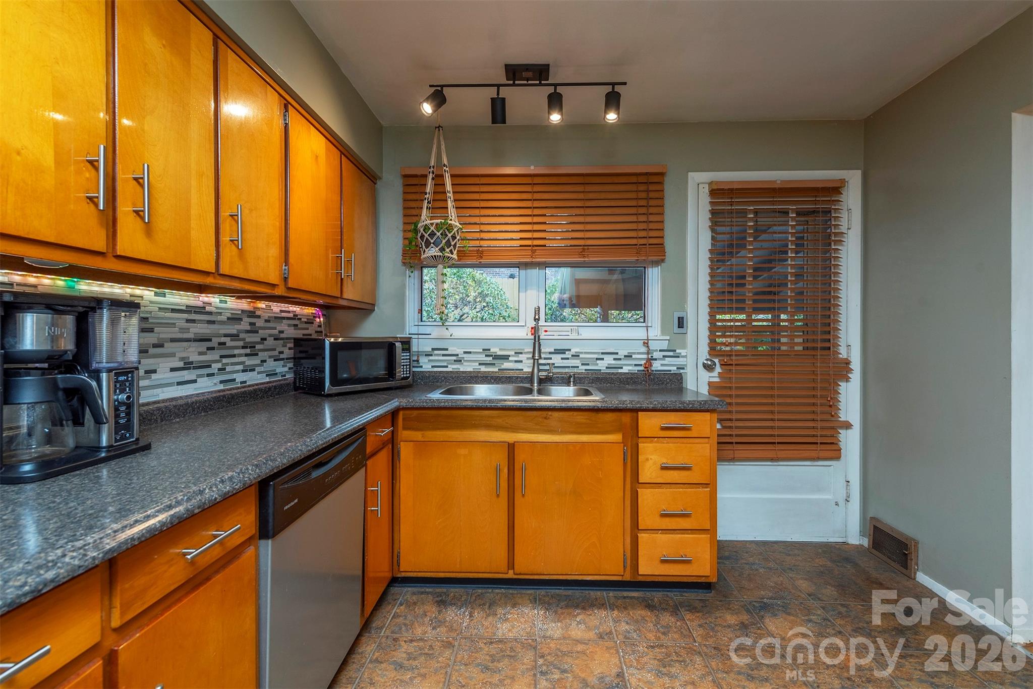 4 Stockwood Road Asheville, NC 28803 - Photo 14 of 41 a kitchen with stainless steel appliances granite countertop sink window and refrigerator