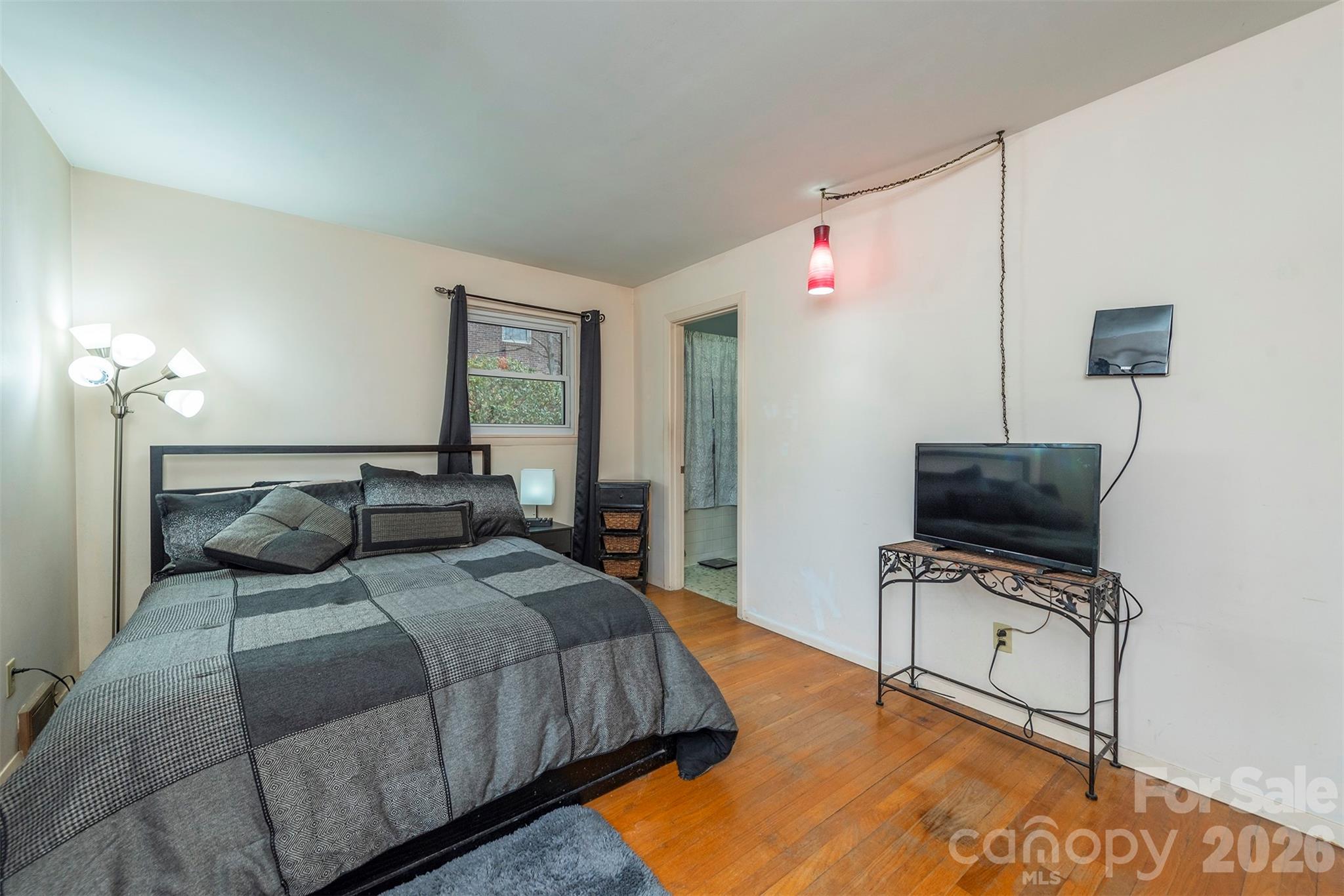 4 Stockwood Road Asheville, NC 28803 - Photo 21 of 41 a bedroom with a bed and a flat screen tv