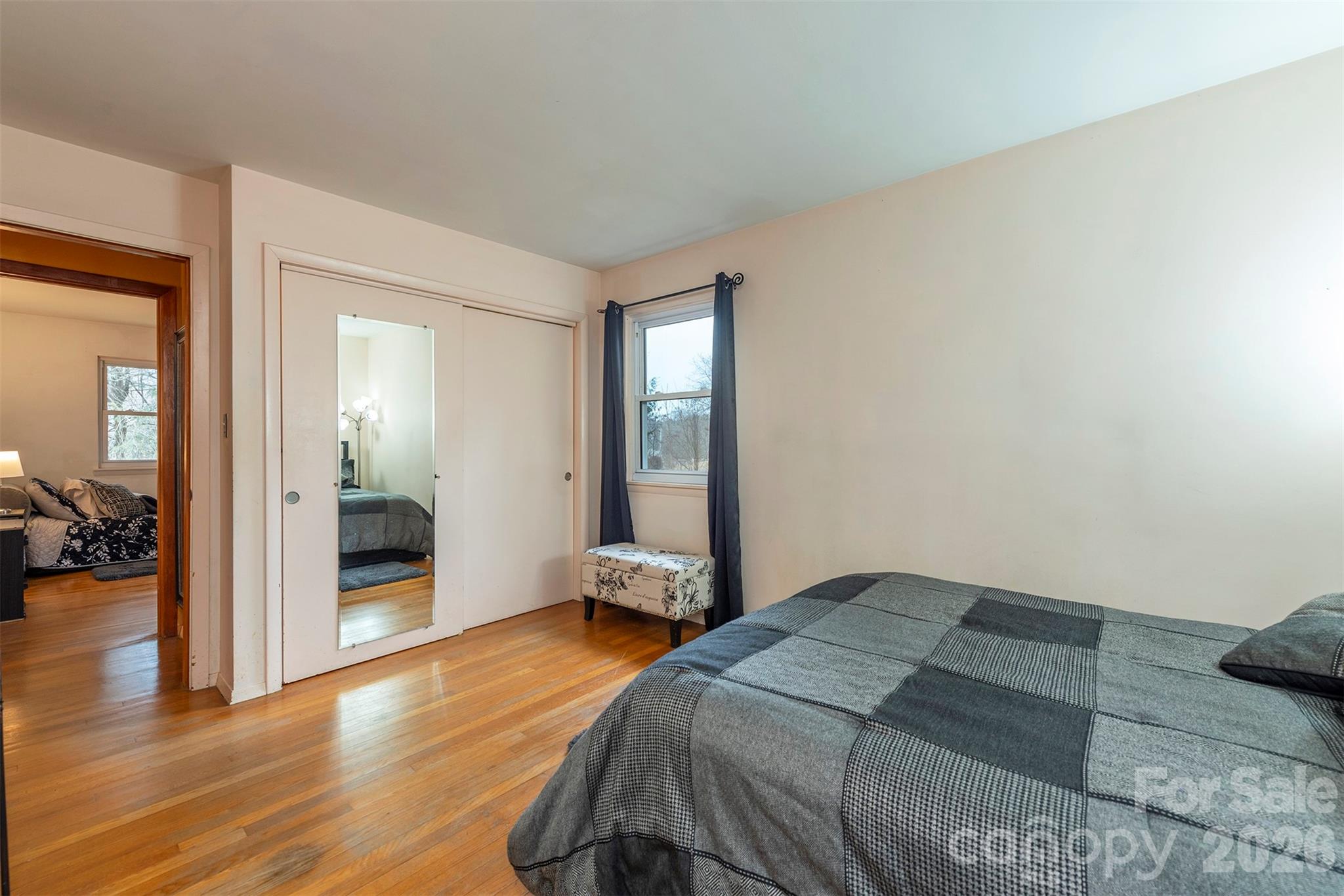 4 Stockwood Road Asheville, NC 28803 - Photo 22 of 41 a bedroom with a bed and wooden floor