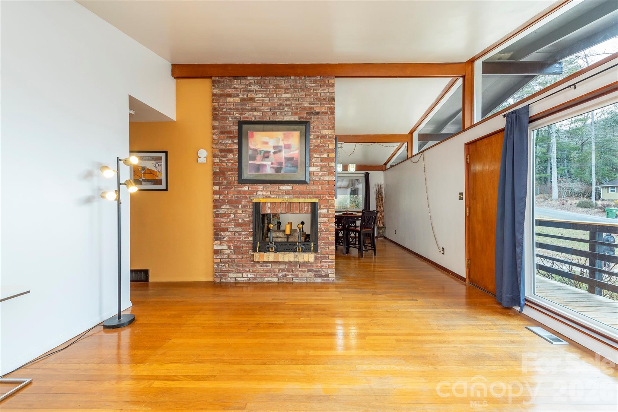 4 Stockwood Road Asheville, NC 28803 - Photo 6 of 41 a view of a livingroom with an empty space and wooden floor