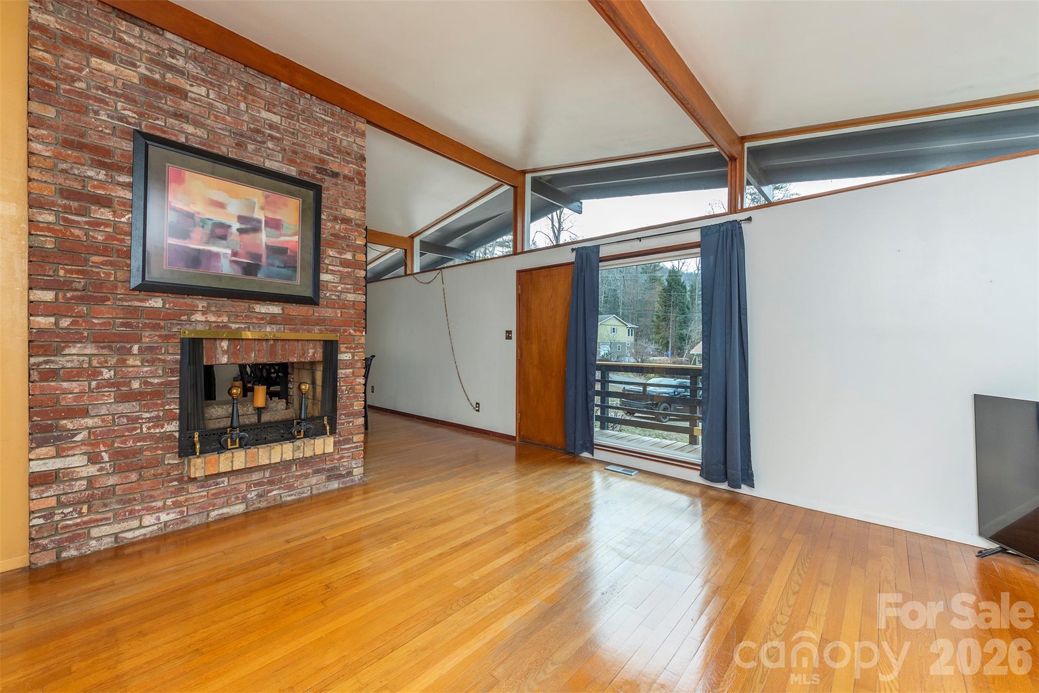 4 Stockwood Road Asheville, NC 28803 - Photo 7 of 41 a view of a livingroom with wooden floor a fireplace and window
