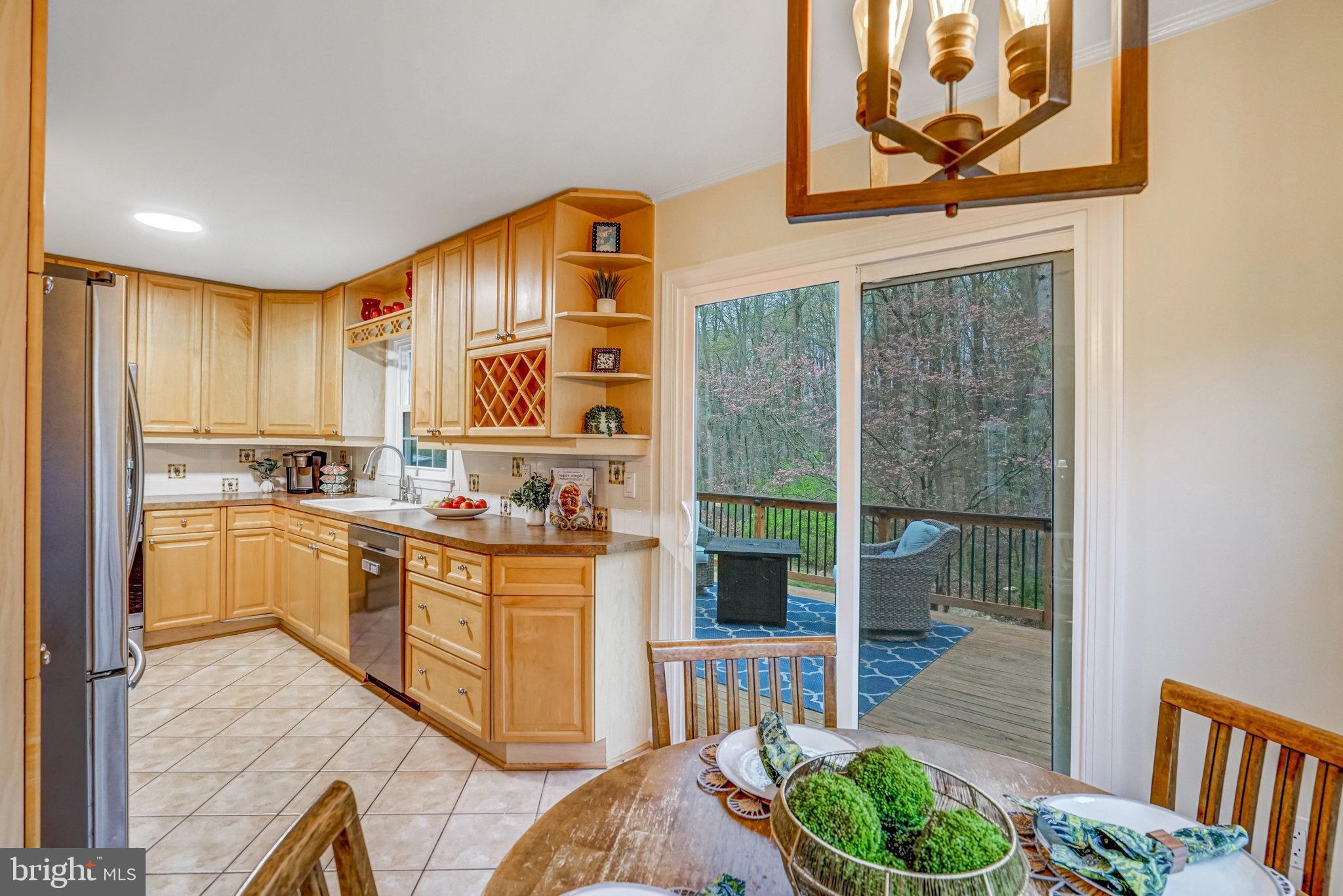 7924 Forest Path Way Springfield, VA 22153 - Photo 11 of 42 a kitchen with stainless steel appliances granite countertop a stove and a sink
