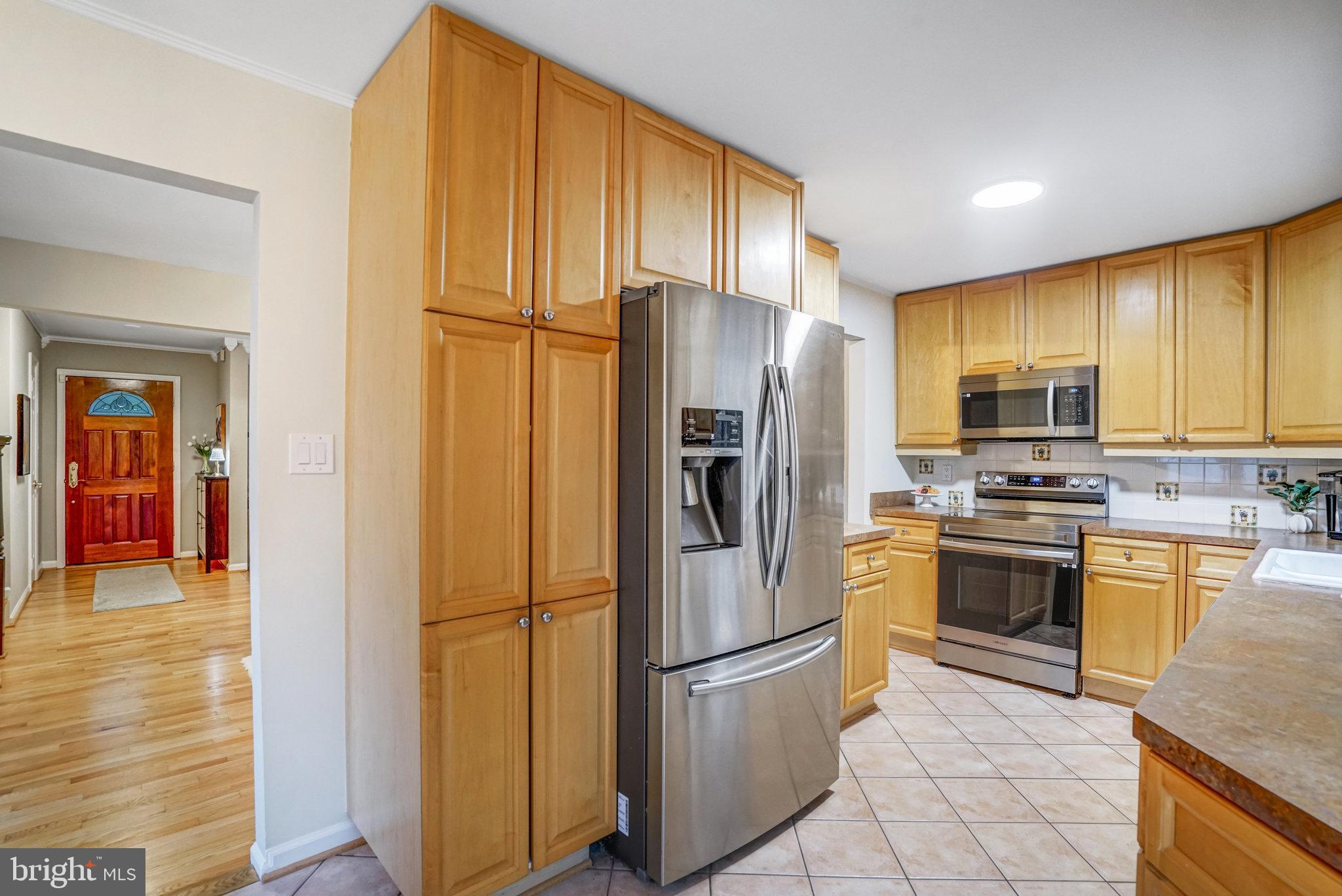 7924 Forest Path Way Springfield, VA 22153 - Photo 12 of 42 a kitchen with stainless steel appliances granite countertop a refrigerator stove microwave and sink