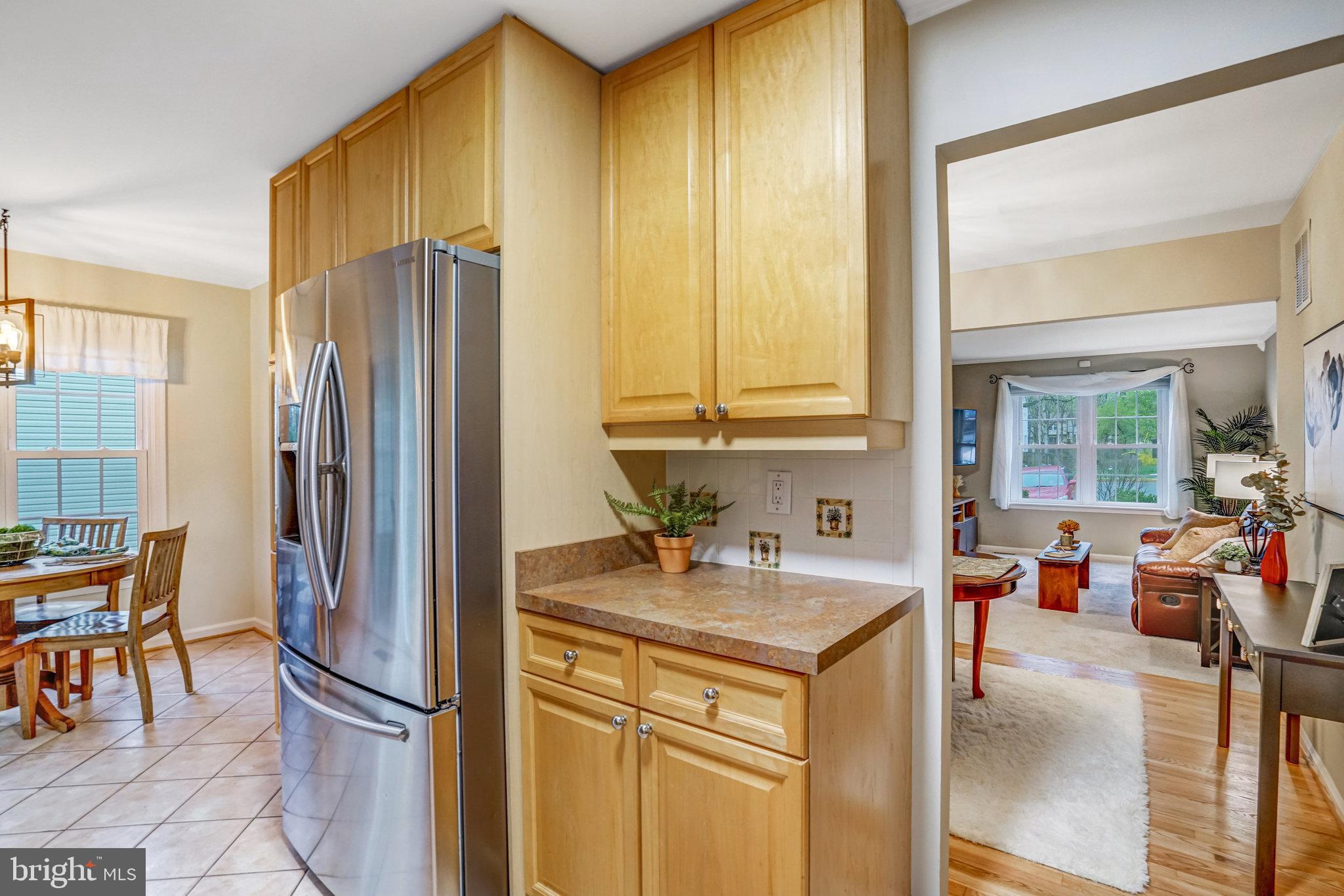 7924 Forest Path Way Springfield, VA 22153 - Photo 13 of 42 a kitchen with stainless steel appliances granite countertop a refrigerator and a sink