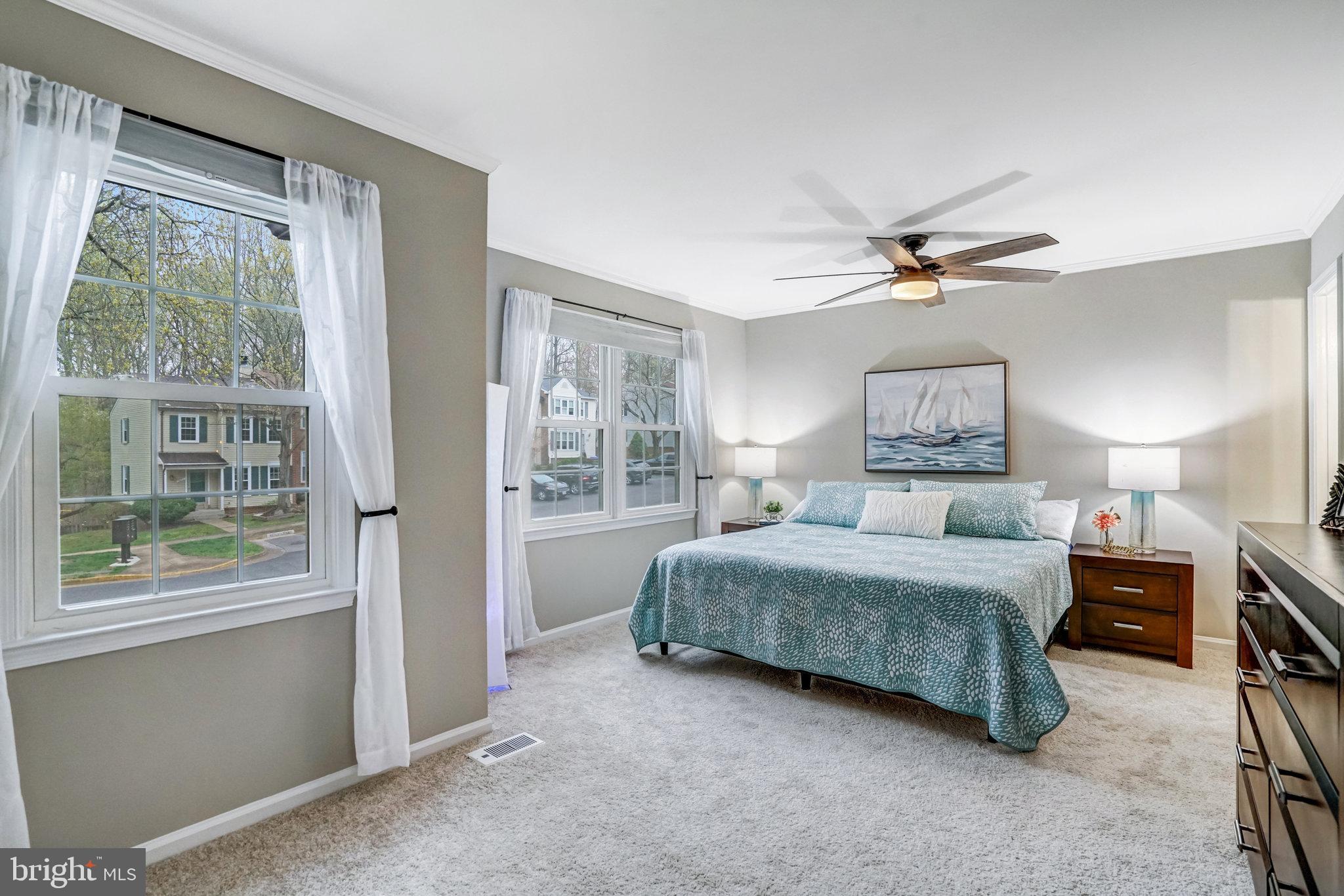 7924 Forest Path Way Springfield, VA 22153 - Photo 19 of 42 a bedroom with a large bed and a chandelier