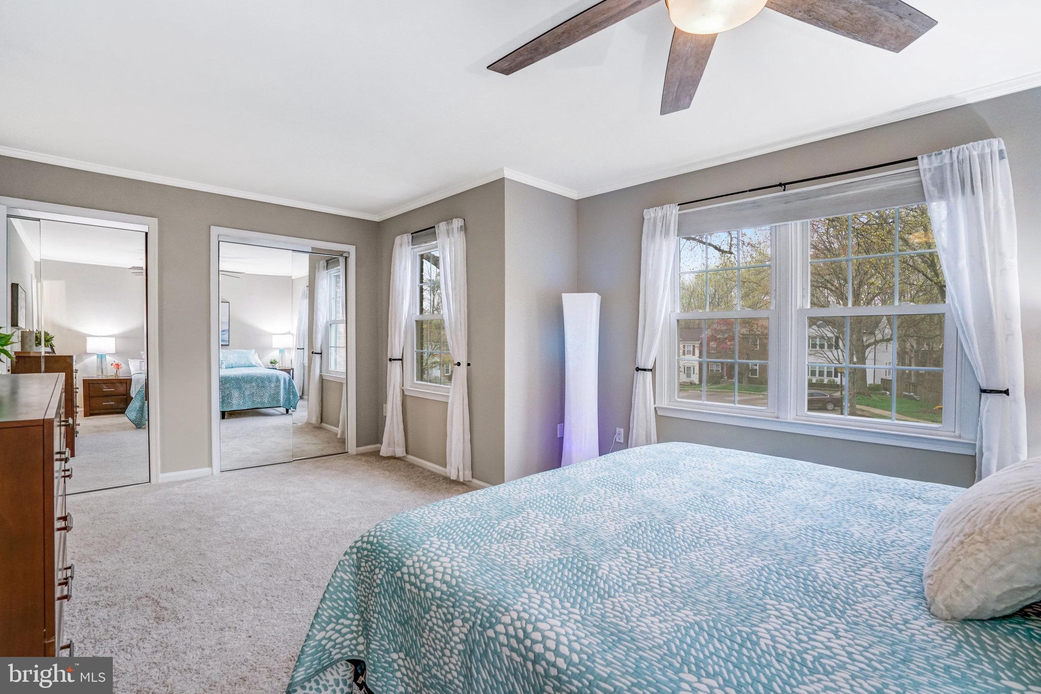7924 Forest Path Way Springfield, VA 22153 - Photo 22 of 42 a spacious bedroom with a large bed and a window