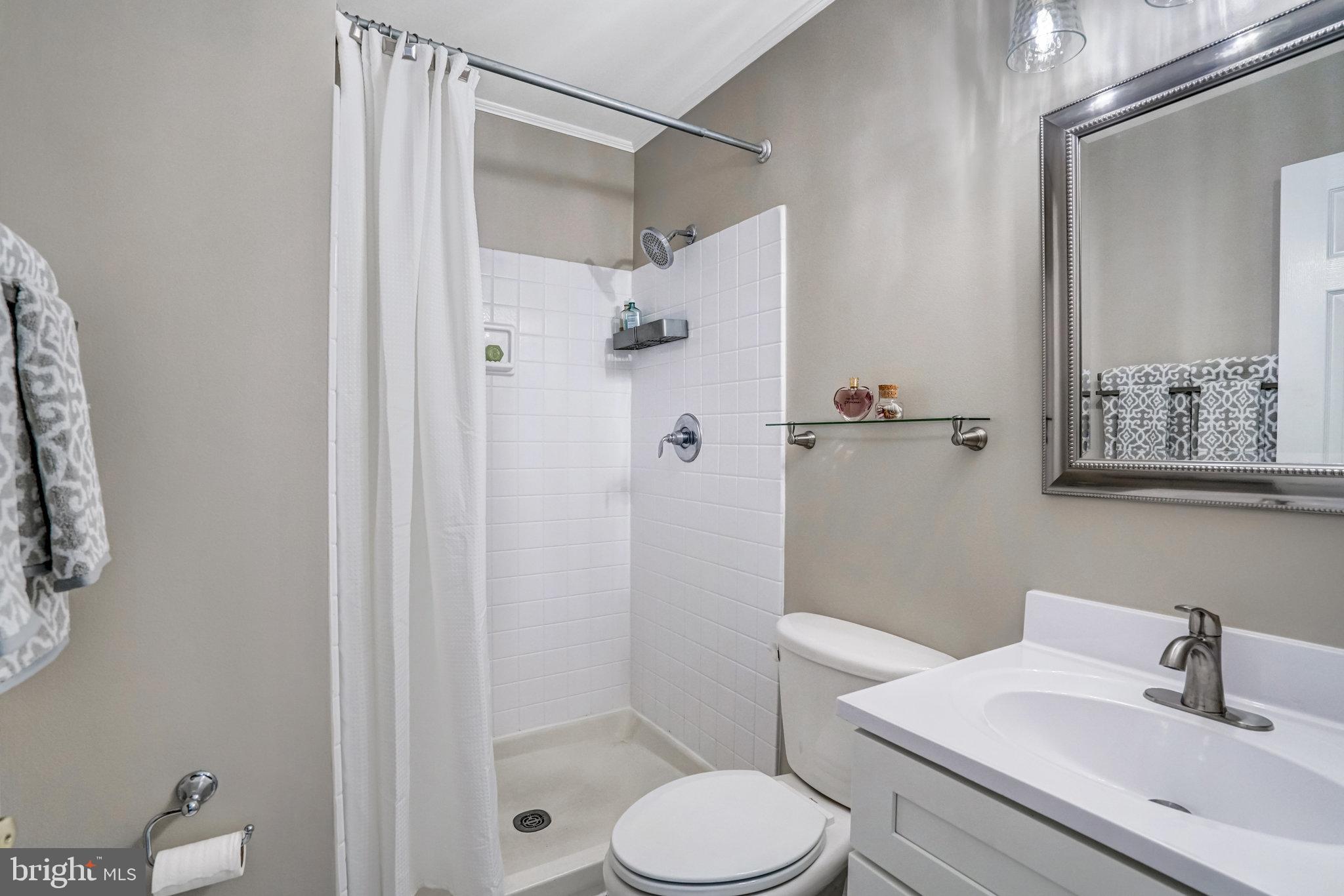 7924 Forest Path Way Springfield, VA 22153 - Photo 24 of 42 a bathroom with a toilet sink and shower