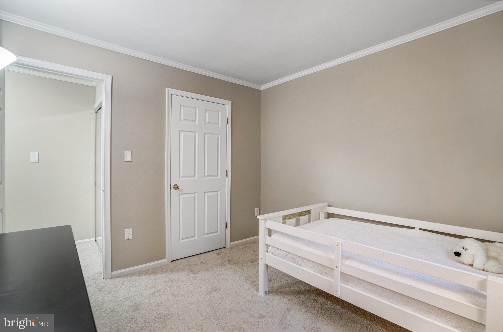 7924 Forest Path Way Springfield, VA 22153 - Photo 27 of 42 a spacious bedroom with a bed and a lamp