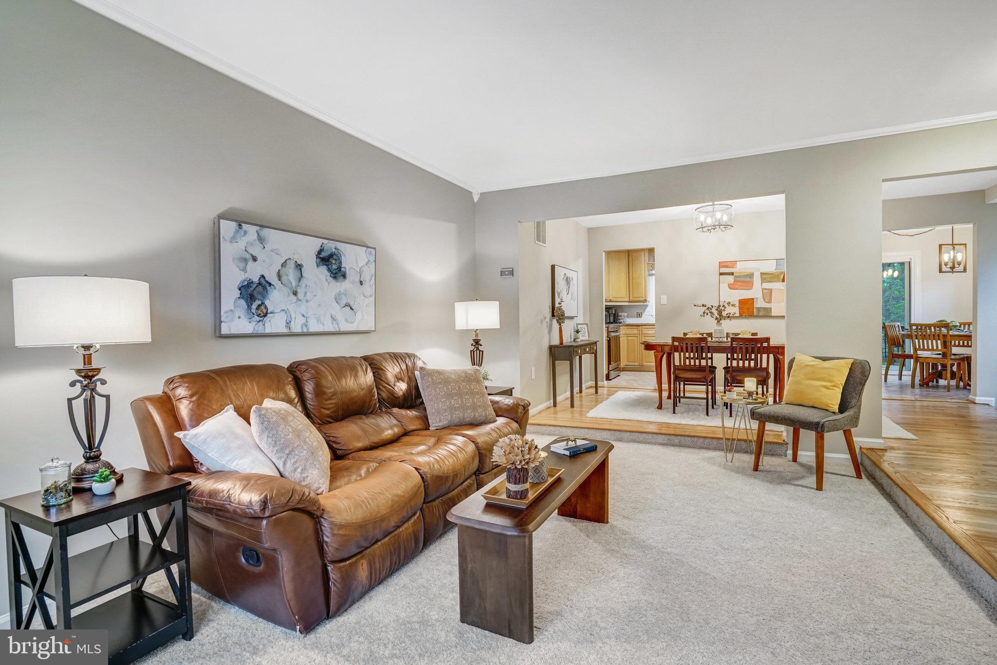 7924 Forest Path Way Springfield, VA 22153 - Photo 7 of 42 a living room with furniture and a painting on the wall